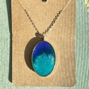 Silver framed oval pendant necklace